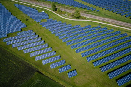 aerial photography of grass field with blue solar panels